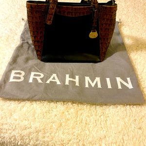 Reselling a small used black & tan Brahmin with shoulder straps. Good condition.